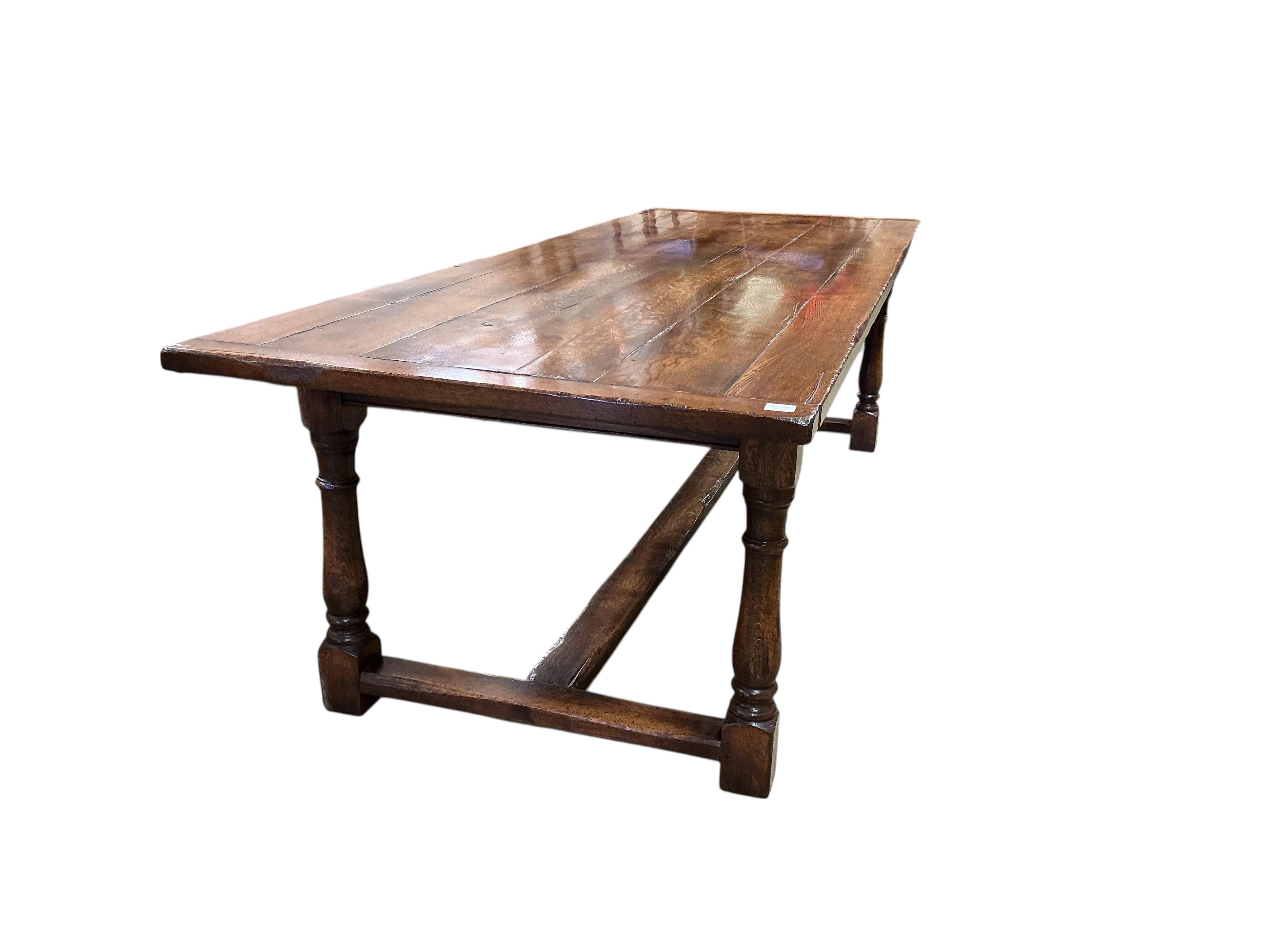 A 17th century style rectangular oak refectory dining table, with cleated six plank top, width 274cm, depth 102cm, height 79cm